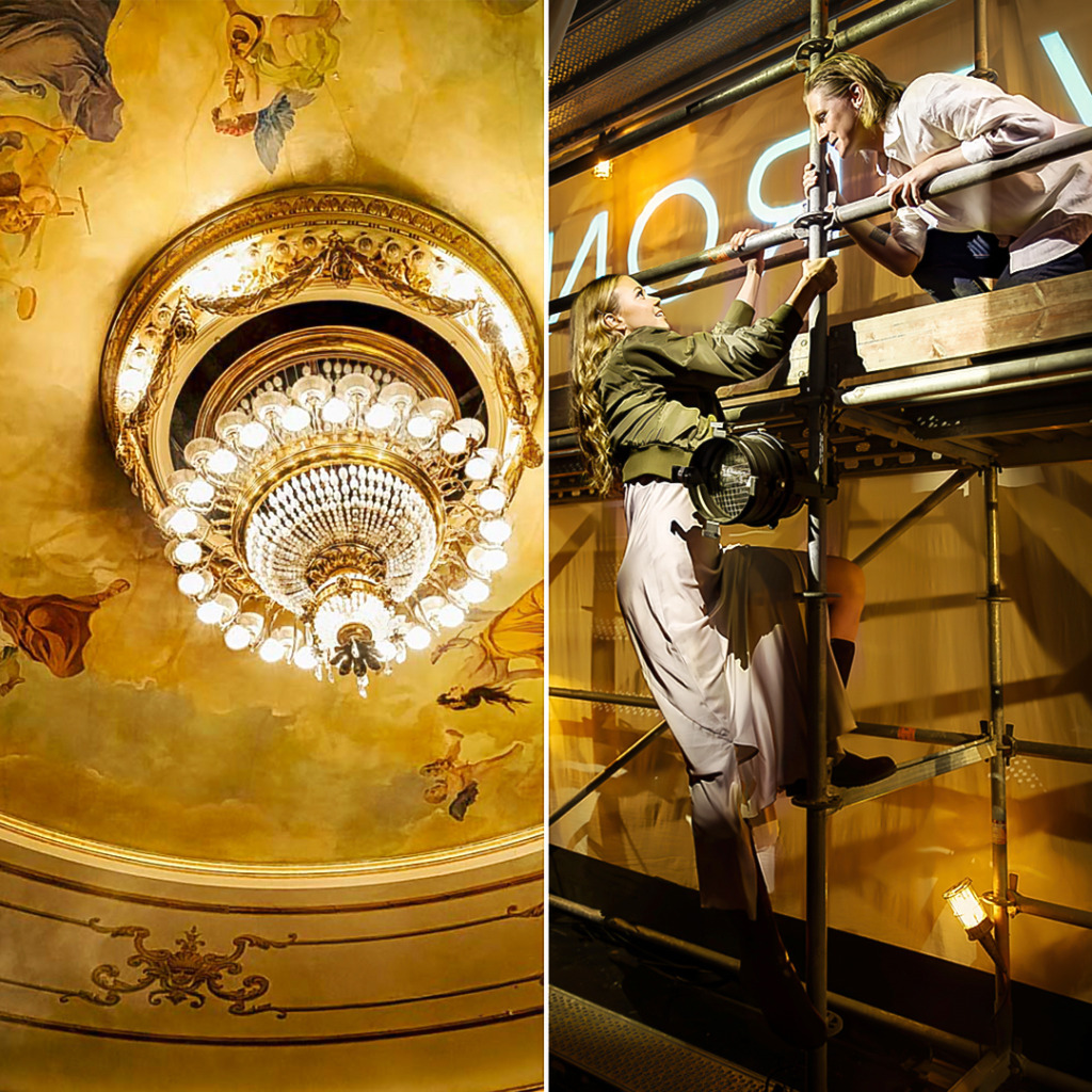 Delad bild. Till vänster syns Åbo Svenska Teaters tak med en stor kristallkrona som lyser varmt under en rikt dekorerad takmålning med figurmotiv i mjuka gula och gyllene toner. Till höger syns två skådespelare på en byggställning på scenen. De lutar sig mot varandra och håller i räcken medan de ser varandra i ögonen, upplysta av scenljus i gult. Scenografin och ljuset skapar en intim och lekfull stämning. Jaettu kuva. Vasemmalla näkyy Åbo Svenska Teaterin kattomaalaus ja suuri kristallikruunu, joka valaisee tilaa lämpimästi. Koristeellisessa kattomaalauksessa on hahmomotiiveja pehmeissä keltaisissa ja kullan sävyissä. Oikealla kaksi näyttelijää on näyttämöllä rakennustelineillä. He nojaavat kaiteisiin, katsovat toisiaan silmiin ja ovat keltaisen näyttämövalon valaisemia. Lavastus ja valaistus luovat intiimin ja leikkisän tunnelman. Split image. On the left, the ceiling of Åbo Svenska Teater is shown with a large crystal chandelier glowing warmly beneath an ornate ceiling painting with figure motifs in soft yellow and golden tones. On the right, two actors are standing on scaffolding on stage. They lean towards each other, holding onto the rails and meeting each other’s gaze, lit by warm yellow stage light. The set design and lighting create an intimate and playful atmosphere.